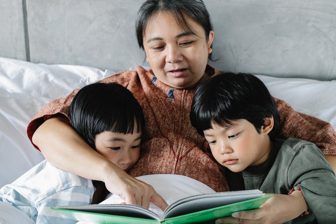 A mother reading a bedtime story for her children